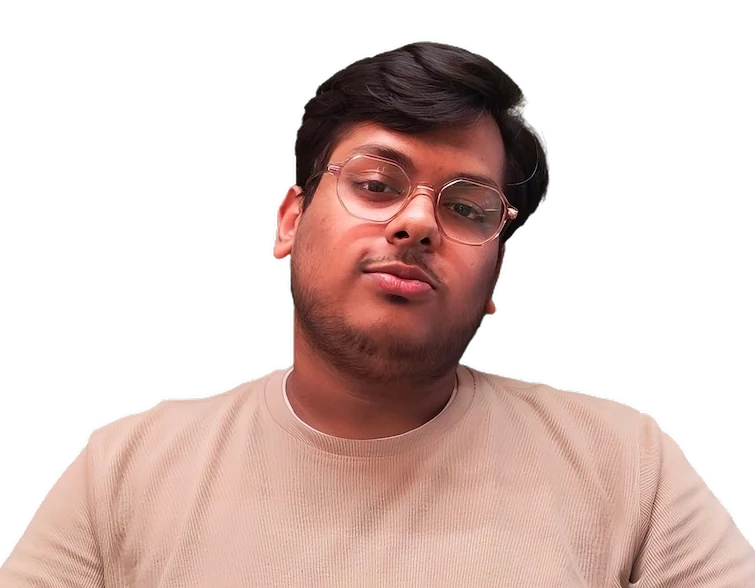 My picture where I am wearing glasses and a beige crew-neck shirt and I am posing in front of a dark background. I have short, dark hair and some facial hair. My head is slightly tilted to the right with a confident smile.